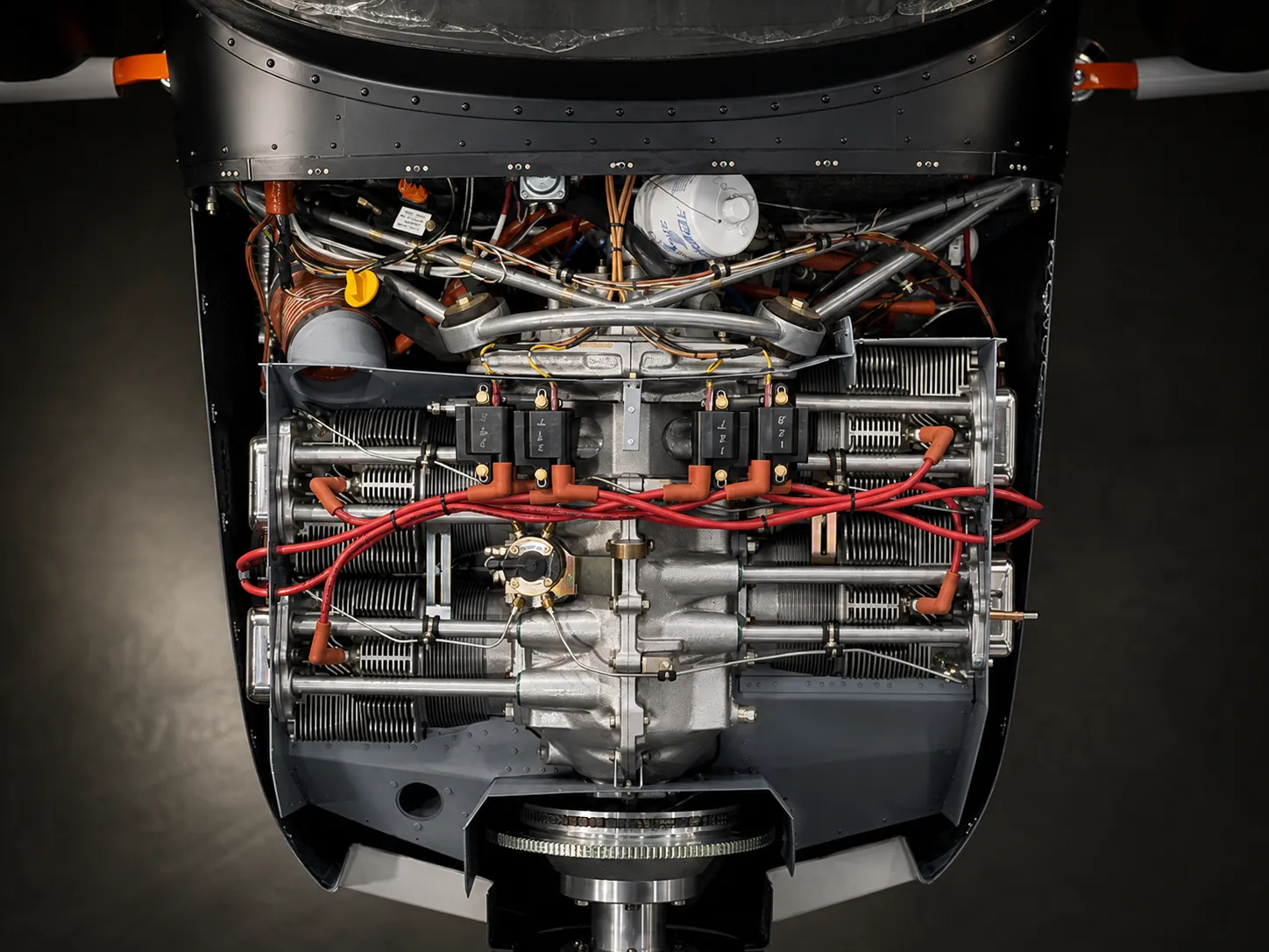 Aircraft engine compartment with exposed cylinders, ignition leads, and firewall-forward systems